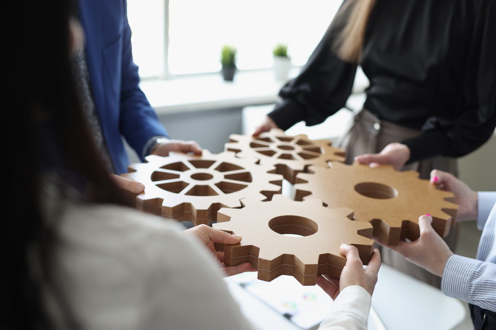 efficient-business-team-connects-wooden-gears-into-one-1